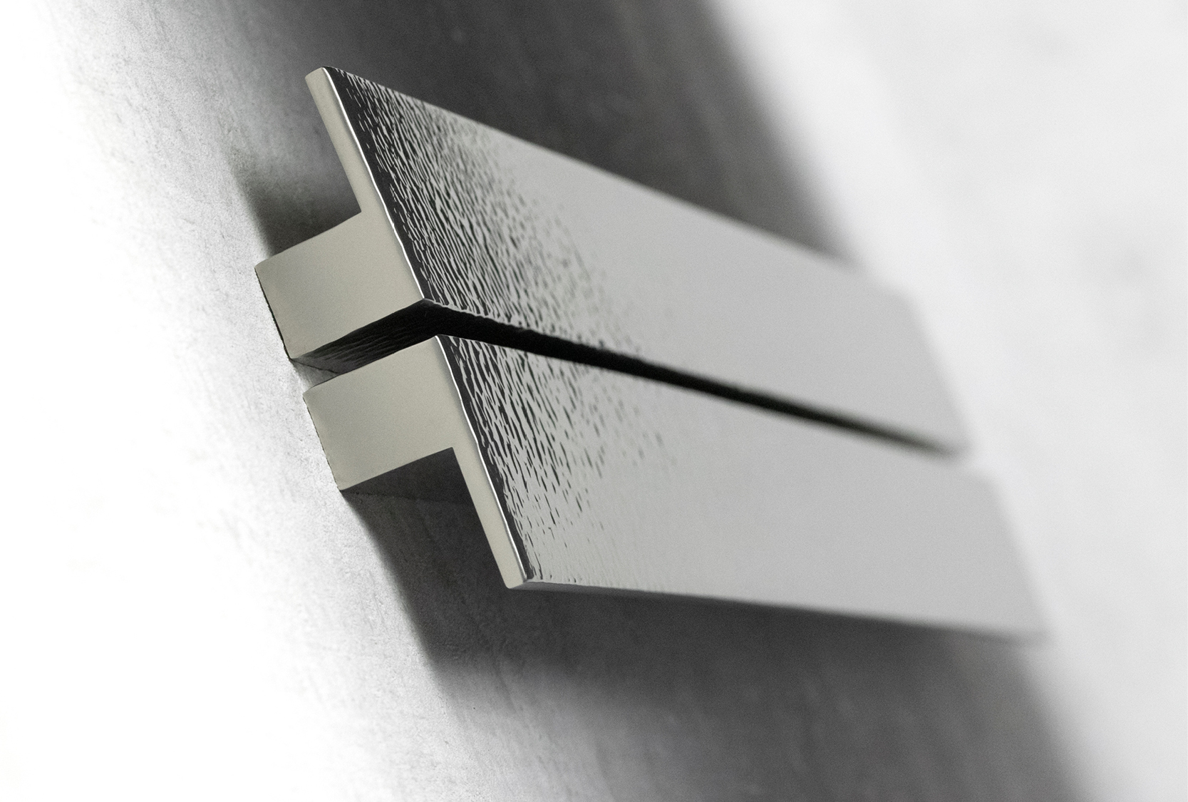 Image is of a custom length solid hammered ledge cabinet pull. The luxury ledge design is handmade and hand hammered by Turnstyle Designs.