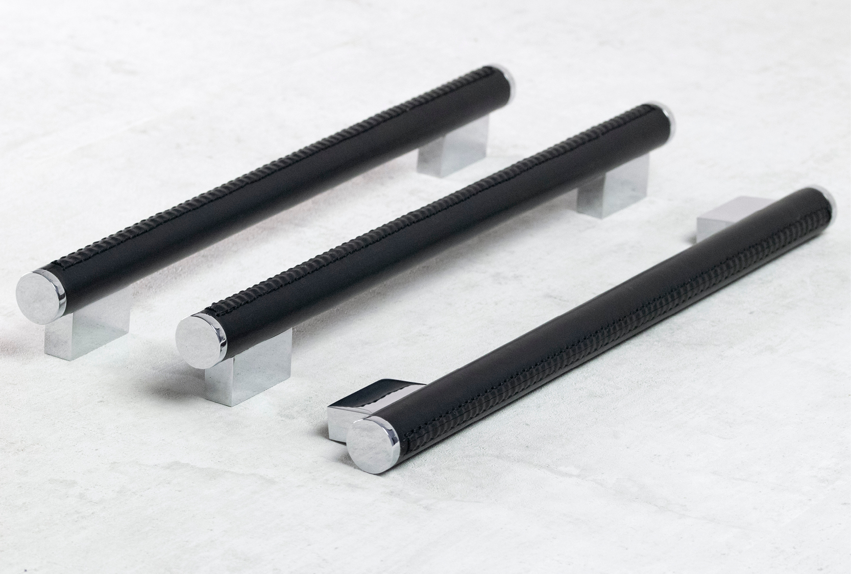 Image of three custom length coffin leg scrolls. Bonded Italian black leather cover the grip. Coffin design legs are finished in bright chrome metal finish.