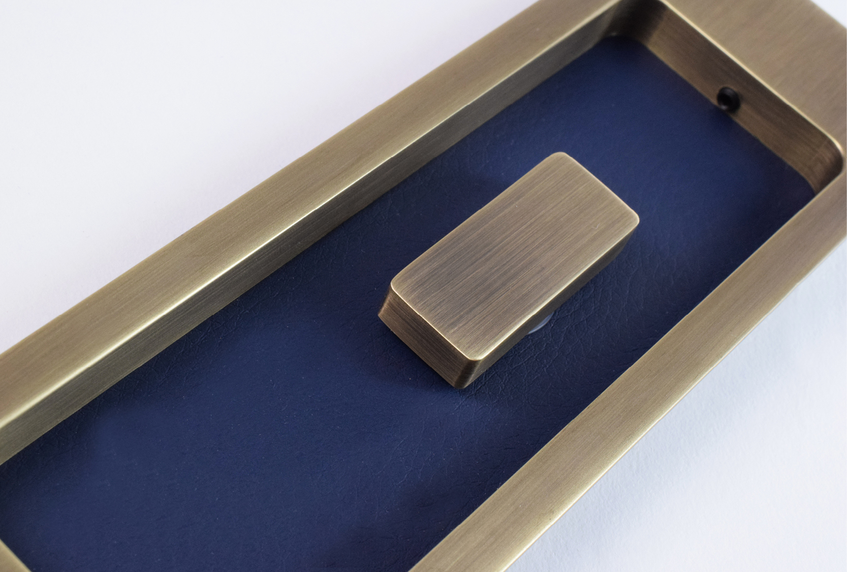 Enlarged image of the custom rectangle flush pull turn. Finished in a custom blue leather with fine antique finish metal finish.