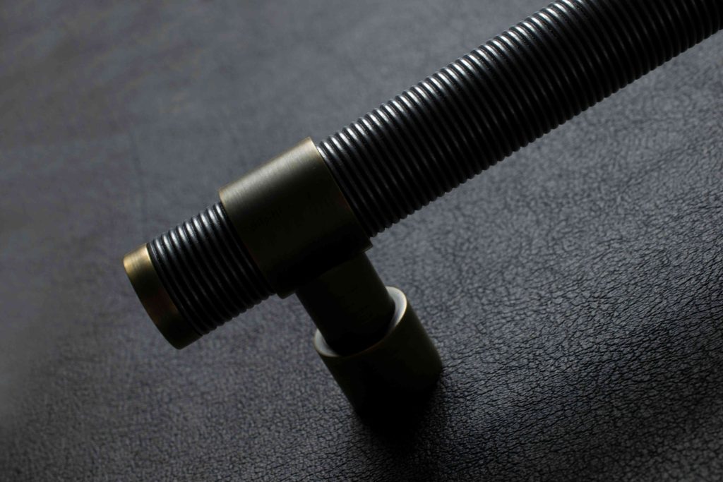 With moody lighting and highlights only hitting the top of the door pull, shown here in their Alupewt and Fine Antique brass finish is the Wire Stepped Amalfine pull handle. This large pull with collared ends and a stepped leg is one of the latest designs from Turnstyle Designs