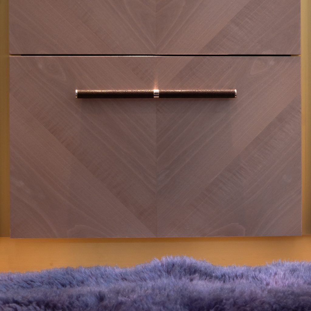 A custom scroll handle on a beautiful book end pattern veneer cabinet. This custom handle created for a neo Georgian property in Jersey was the perfect choice for custom hardware by Turnstyle Designs.