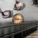 House of the hunter project by FORM studio interior design. Central to this image of a brids eye view from the stairs show the unique and striking wine circular wine cellar in the concrete floor.