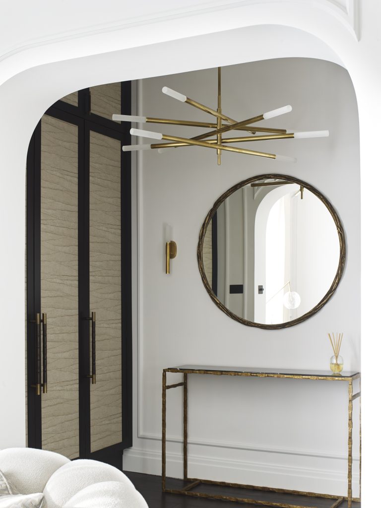 Custom made cupboards for dressing area in a luxury London based apartment. Decorative Bamboo design pull handle from Turnstyle Designs were chosen for the handles. The panelled cupboard doors are lined with textured wall coverings.