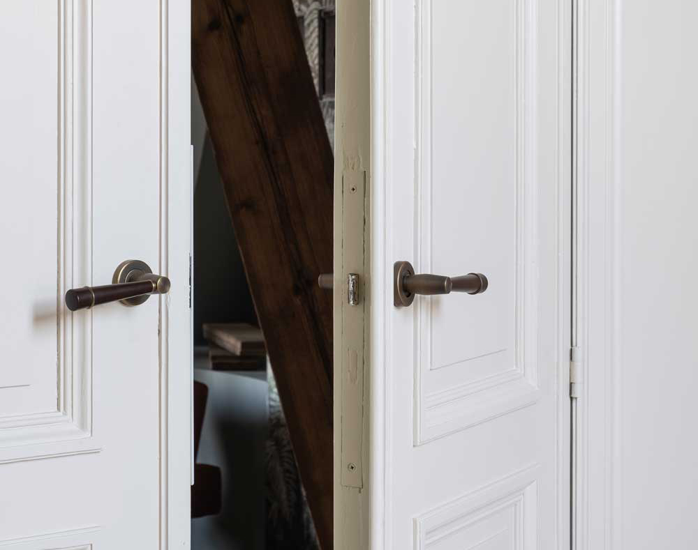 Bespoke, handmade luxury door levers have been used on these newly restored double doors in a luxury, Antwerp based apartment.