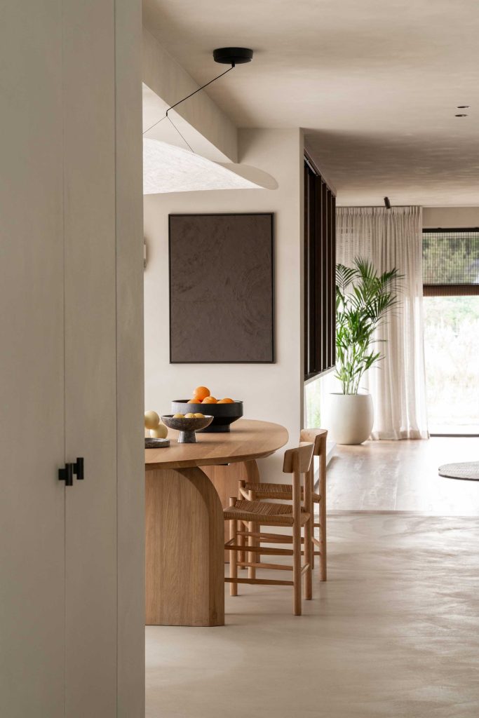Luxury family home interior with minimalistic style. Scroll cabinet t bars from Turnstyle Designs in the foreground of the image have been used on the large cupboard doors.