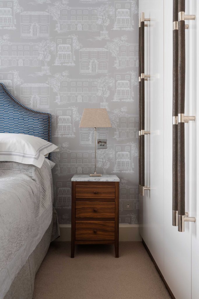 Luxury London apartment in Marylebone with large Turnstyle Designs multi grip door pulls on bespoke wardrobe cupboard doors. Shown here in the master bedroom on light grey painted doors with decorative wallpaper and head board.